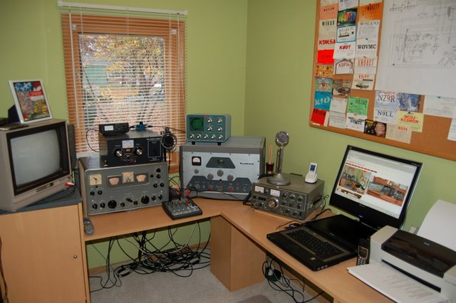 Mike's shack showing Hammarlund HQ170, DX-100, MFJ antenna tuner, Kenwood TS-520. A TV monitor, notebook computer and printer round out the shack.